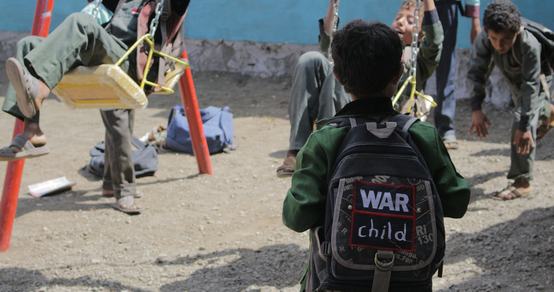 Boy with his backpack playing outside_War Child UK in Yemen_181107