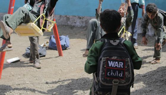 Boy with his backpack playing outside_War Child UK in Yemen_181107