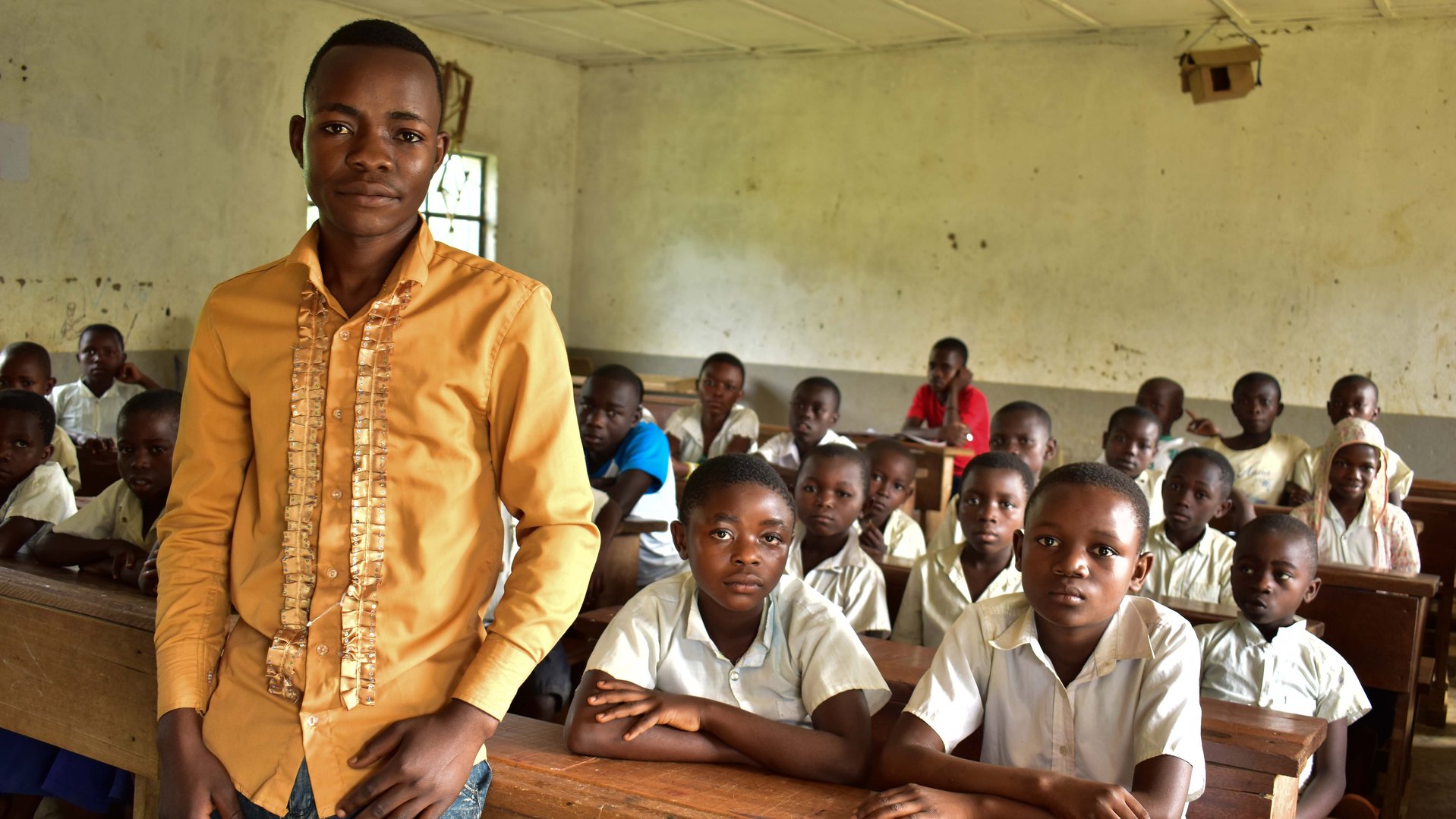 A teacher in Uganda, standing in front of the class