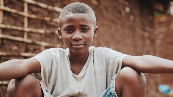 Nelson looking straight into the camera - participating in War Child programmes in Uganda