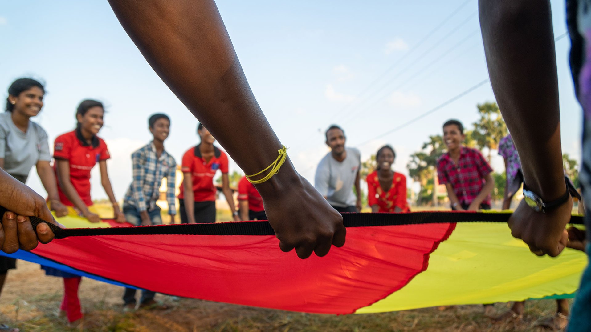 Children are participating in TeamUp in Sri Lanka - parachute game