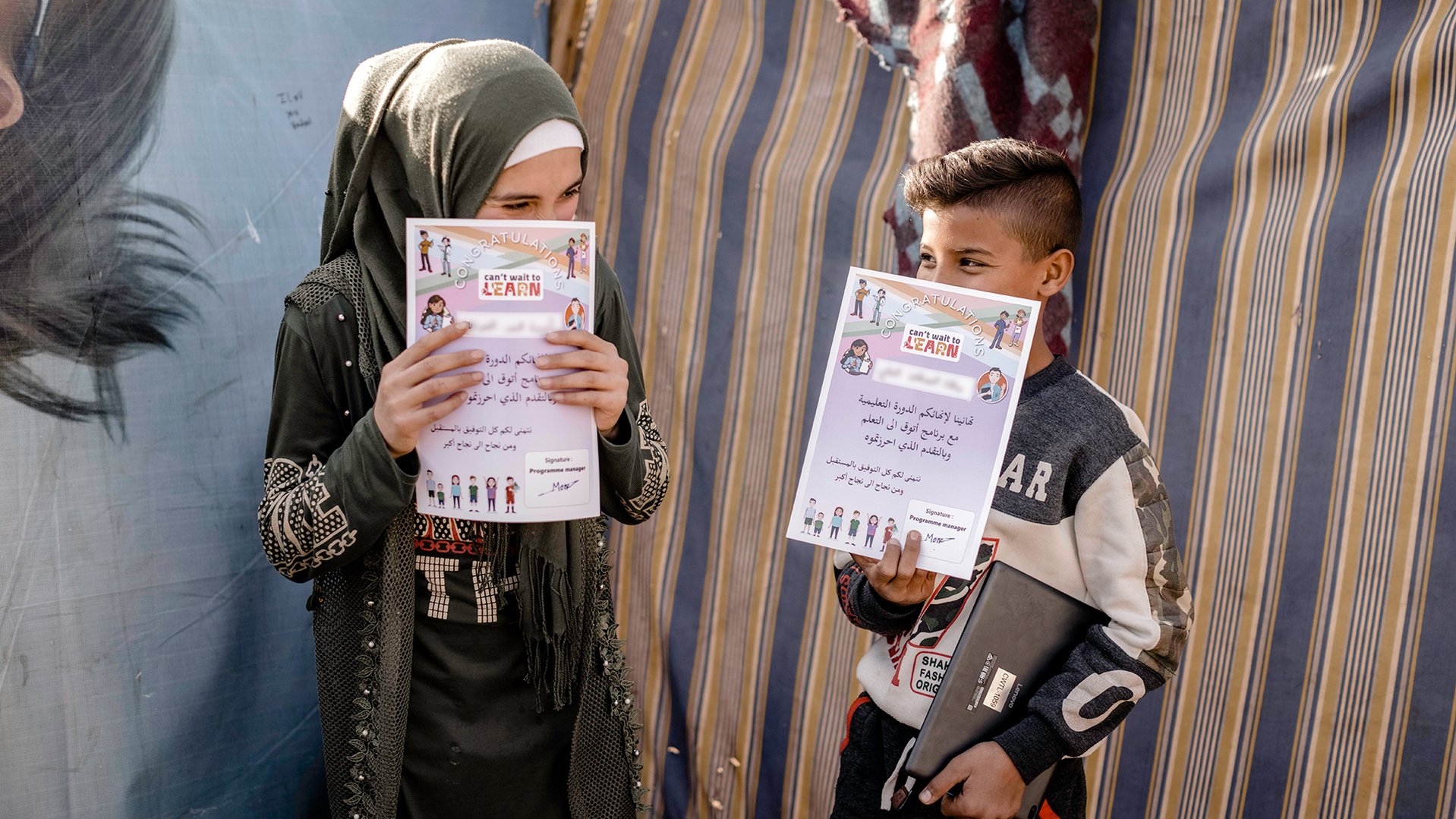 Two friends celebrating their graduation from War Child's Can't Wait to Learn Program