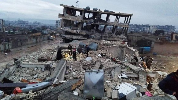 Rubbles and a building about to fall because of the earthquake in Syria